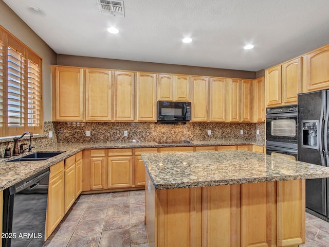 kitchen with a sink, tasteful backsplash, light brown cabinets, visible vents, and black appliances