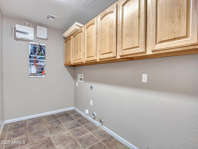 laundry area featuring gas dryer hookup, washer hookup, baseboards, hookup for an electric dryer, and cabinet space