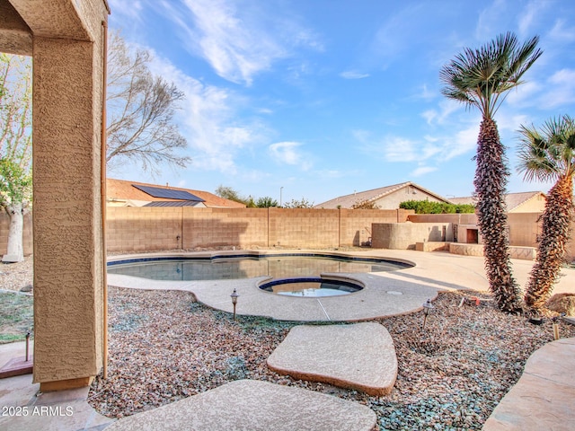 view of yard with a fenced backyard, a fenced in pool, and an in ground hot tub