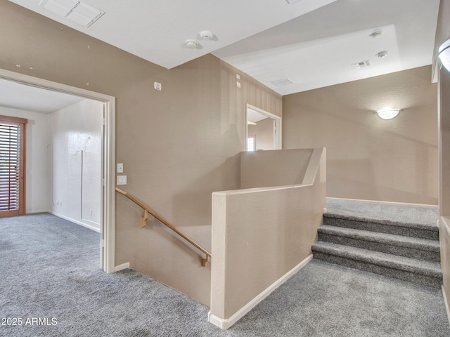 stairs featuring baseboards, visible vents, and carpet