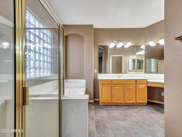 bathroom featuring baseboards, a stall shower, and vanity