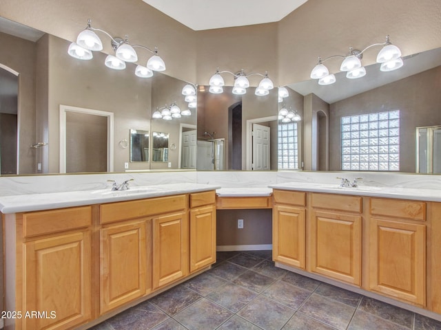 bathroom with a sink, vaulted ceiling, a shower stall, and two vanities