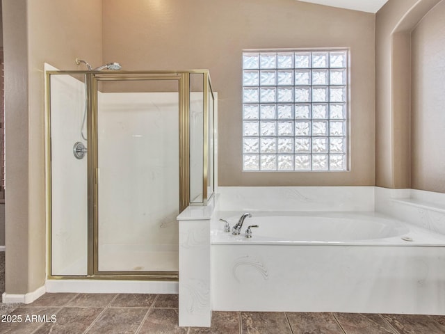 full bathroom featuring lofted ceiling, a garden tub, and a shower stall