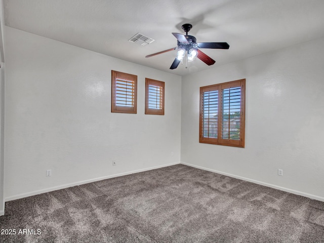 spare room featuring baseboards, visible vents, carpet, and a ceiling fan