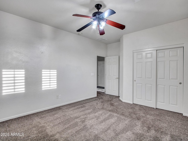 unfurnished bedroom with a closet, visible vents, carpet, baseboards, and ceiling fan