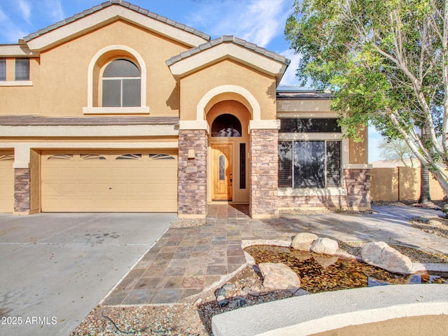 view of front facade featuring stone siding, driveway, stucco siding, and an attached garage