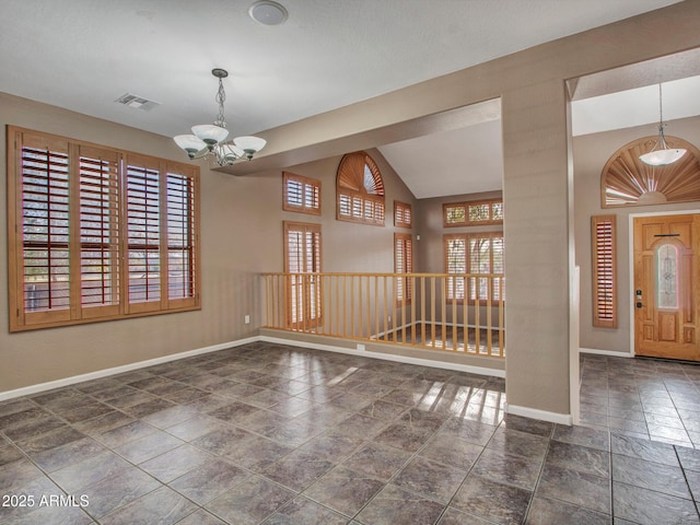 interior space featuring baseboards, lofted ceiling, visible vents, and an inviting chandelier