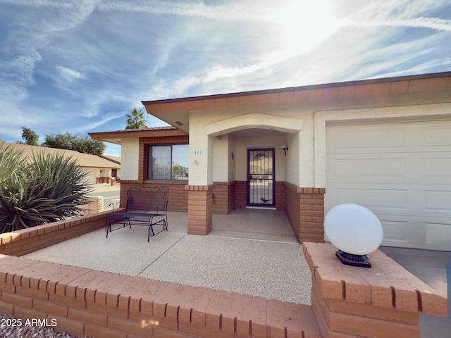 view of exterior entry with a garage