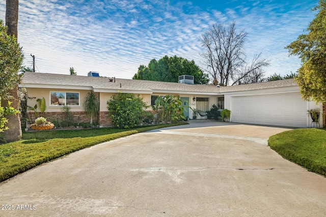 ranch-style home featuring a garage and central AC