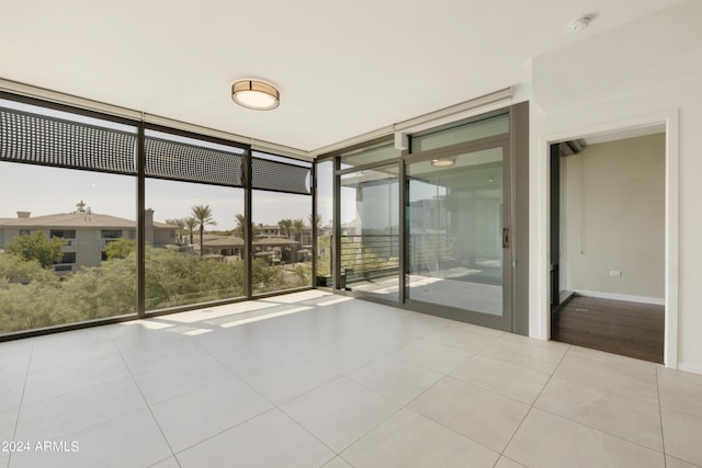 7120 E Kierland Blvd Unit 316, Scottsdale, AZ 85254 - tiled spare room with floor to ceiling windows, a smoke detector, and baseboards