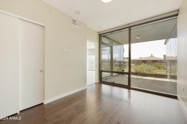 7120 E Kierland Blvd Unit 316, Scottsdale, AZ 85254 - empty room with floor to ceiling windows, wood finished floors, and baseboards