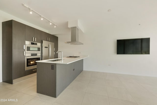 7120 E Kierland Blvd Unit 316, Scottsdale, AZ 85254 - kitchen featuring a sink, wall chimney exhaust hood, a peninsula, stainless steel appliances, and light countertops