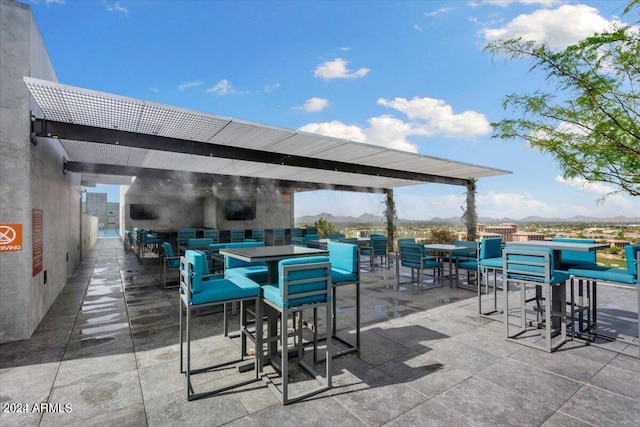 7120 E Kierland Blvd Unit 316, Scottsdale, AZ 85254 - view of patio with a mountain view and outdoor dining area