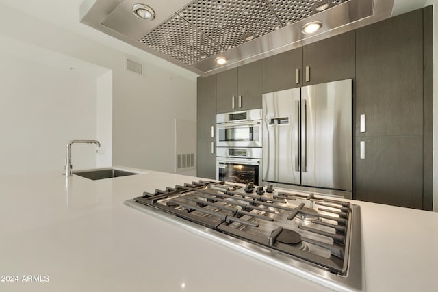 7120 E Kierland Blvd Unit 316, Scottsdale, AZ 85254 - kitchen with stainless steel appliances, a sink, light countertops, and wall chimney exhaust hood