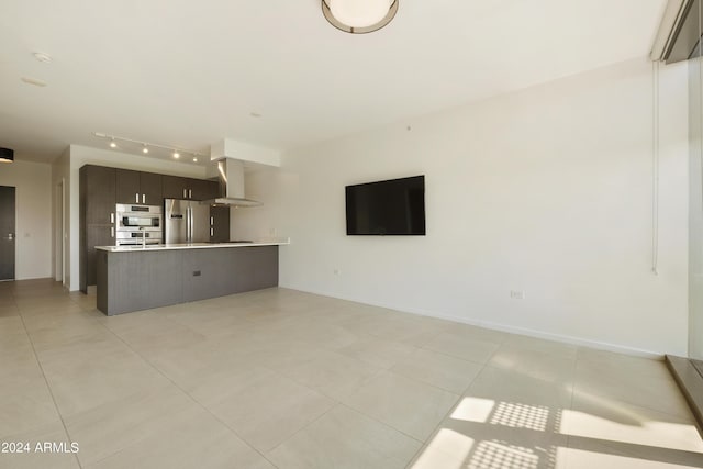 7120 E Kierland Blvd Unit 316, Scottsdale, AZ 85254 - unfurnished living room with light tile patterned floors and track lighting