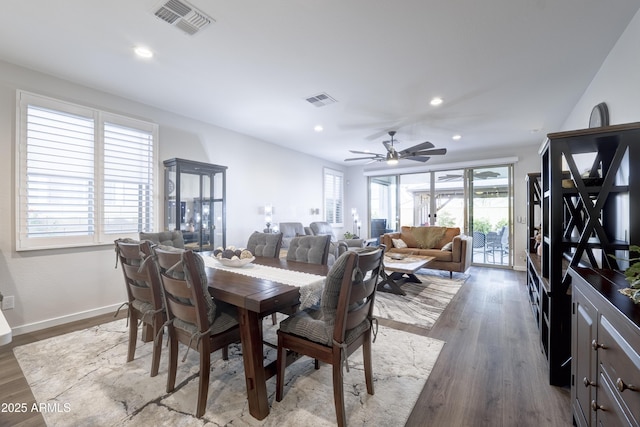 dining room featuring visible vents, a wealth of natural light, and wood finished floors