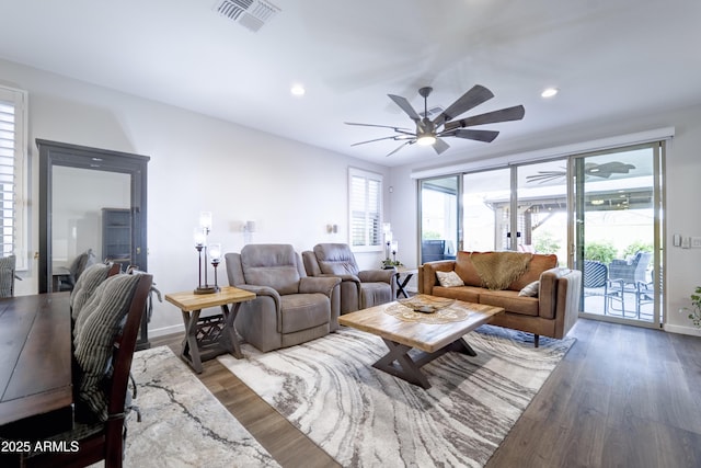 living room featuring visible vents, wood finished floors, and recessed lighting