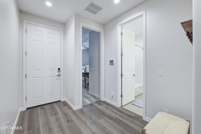 entrance foyer with baseboards, visible vents, wood finished floors, and recessed lighting