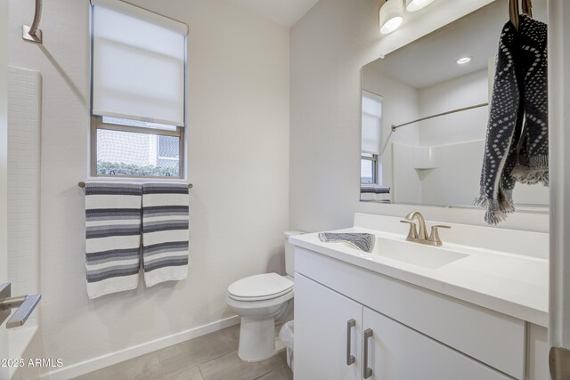 bathroom featuring baseboards, a shower, toilet, tile patterned flooring, and vanity