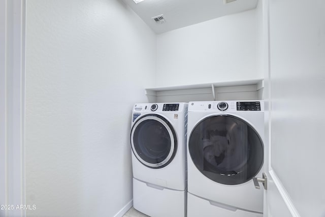 laundry area featuring laundry area, visible vents, and washing machine and clothes dryer