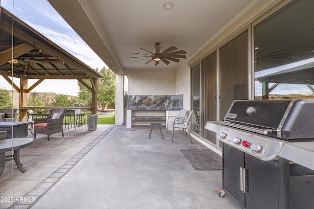 view of patio featuring ceiling fan, a gazebo, and area for grilling