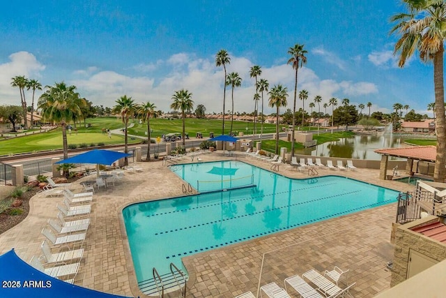 view of swimming pool with a water view and a patio area