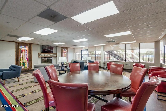 dining space featuring a paneled ceiling and a wealth of natural light