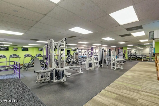 gym with a paneled ceiling