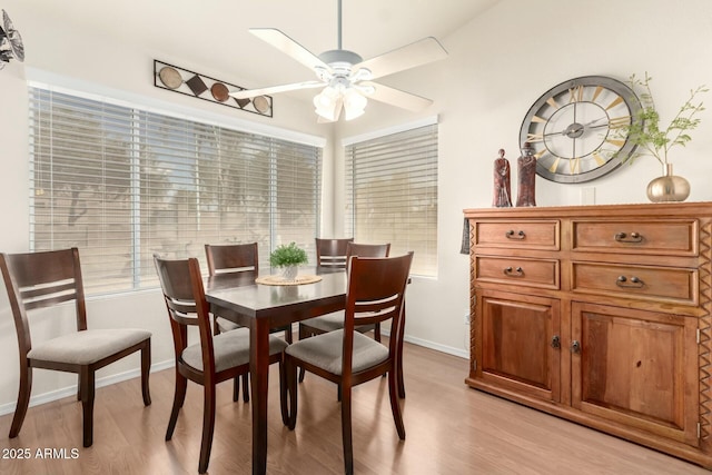 dining room with light hardwood / wood-style floors, ceiling fan, and a healthy amount of sunlight