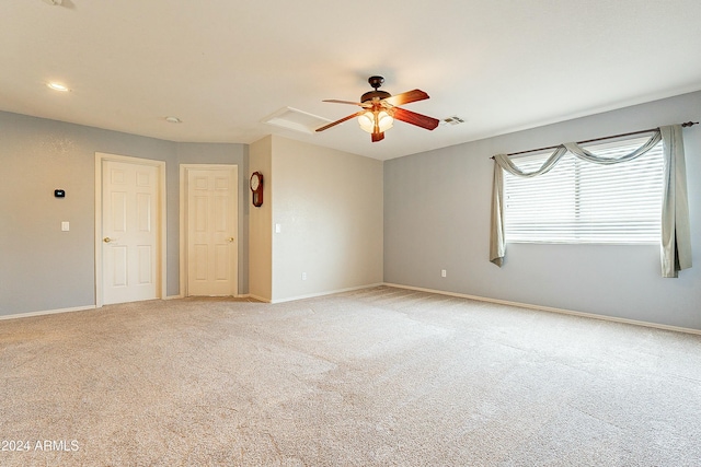 unfurnished room featuring light carpet