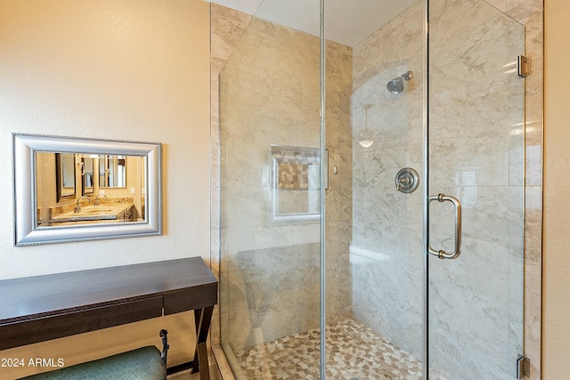 bathroom with sink and a shower with shower door