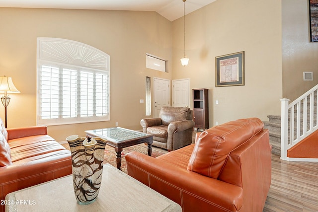 living room with hardwood / wood-style floors and vaulted ceiling