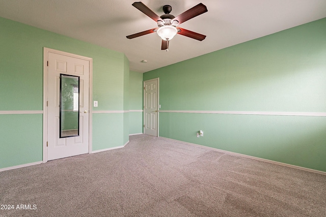 carpeted empty room with ceiling fan