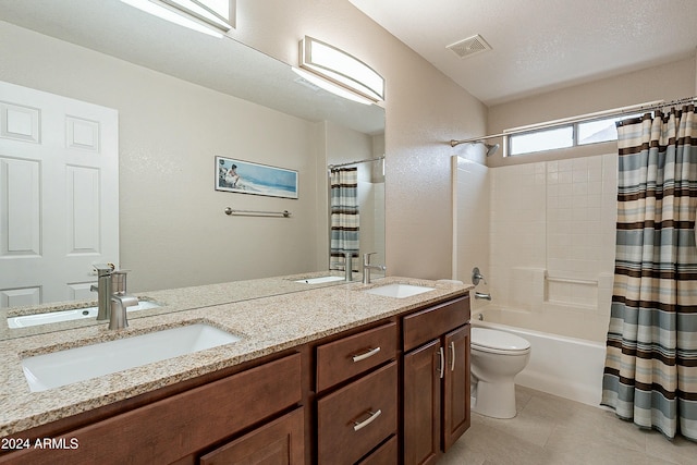 full bathroom featuring shower / tub combo, vanity, a textured ceiling, tile patterned flooring, and toilet