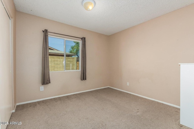 16814 N 31st Ave, Phoenix, AZ 85053 - carpeted empty room with baseboards and a textured ceiling