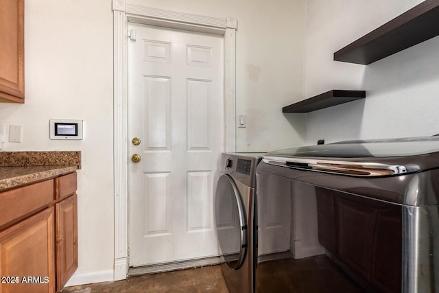 16814 N 31st Ave, Phoenix, AZ 85053 - clothes washing area featuring baseboards, cabinet space, and washing machine and clothes dryer
