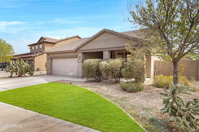 view of front facade featuring a tile roof, stucco siding, concrete driveway, a front yard, and a garage