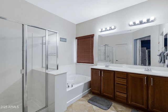 bathroom featuring double vanity, tile patterned floors, a garden tub, a shower stall, and a sink