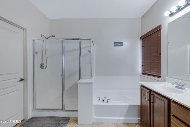 bathroom with a stall shower, a garden tub, vanity, and tile patterned floors