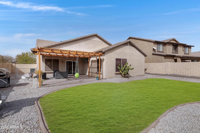 rear view of house with a lawn, stucco siding, a fenced backyard, and a pergola