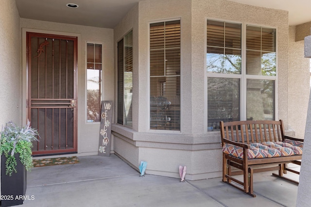 property entrance with stucco siding