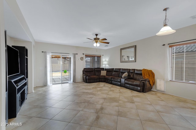 living room featuring ceiling fan, light tile patterned flooring, and visible vents