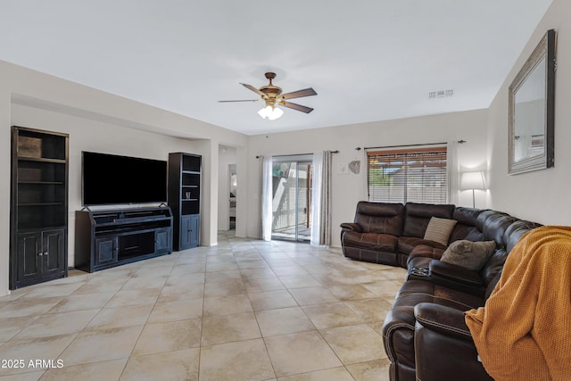 living room featuring ceiling fan, visible vents, and light tile patterned flooring