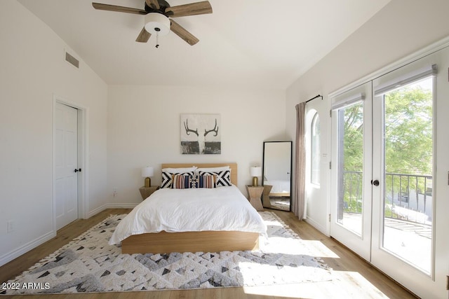 bedroom featuring light wood-style flooring, a ceiling fan, baseboards, visible vents, and access to exterior