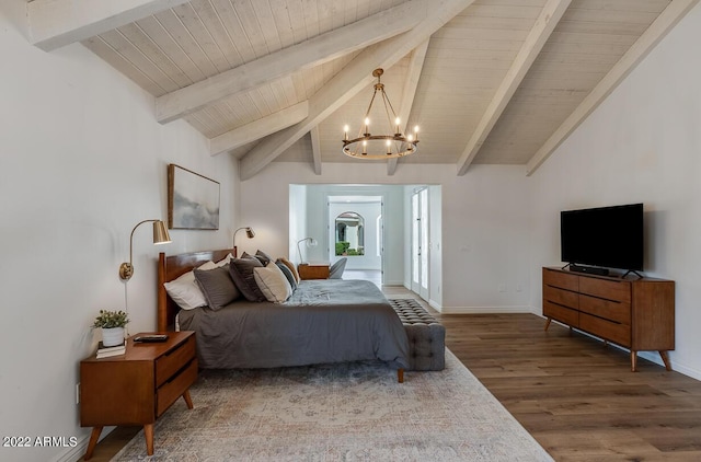 bedroom featuring vaulted ceiling with beams, baseboards, wood finished floors, and an inviting chandelier