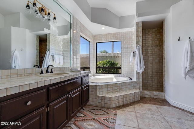 full bathroom with lofted ceiling, vanity, a bath, tile patterned flooring, and walk in shower