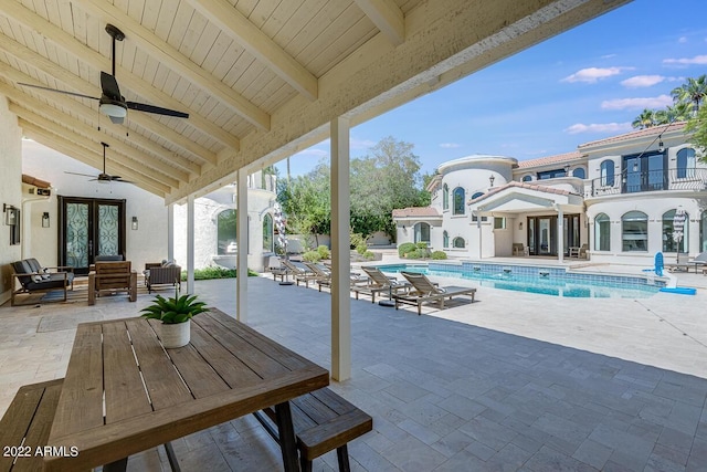 view of patio featuring an outdoor pool, a ceiling fan, and french doors