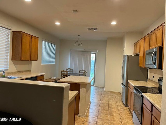 kitchen featuring sink, electric stove, pendant lighting, a center island, and light tile patterned flooring