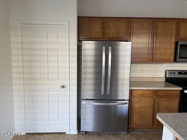 kitchen featuring tile patterned floors and stainless steel appliances