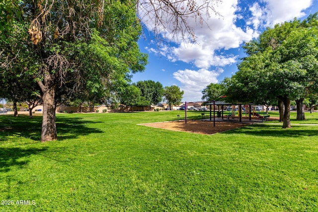 surrounding community featuring playground community and a yard